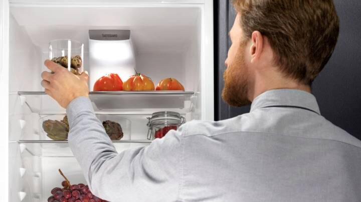 Ένας άνδρας ανοίγει ένα ψυγείο electrolux