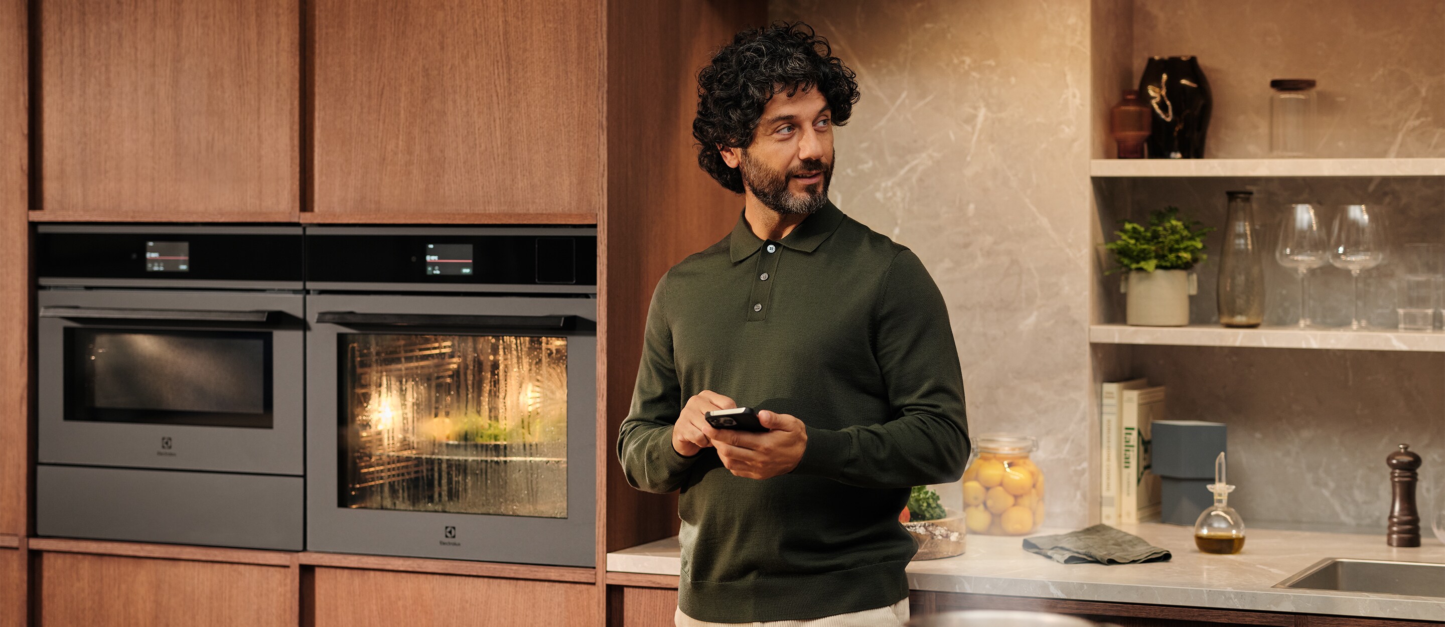 A man is standing in a kitchen.