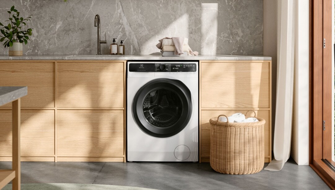 Laundry room with a washing machine placed below a counter