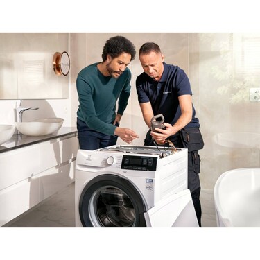technician repairing an electrolux washing machine
